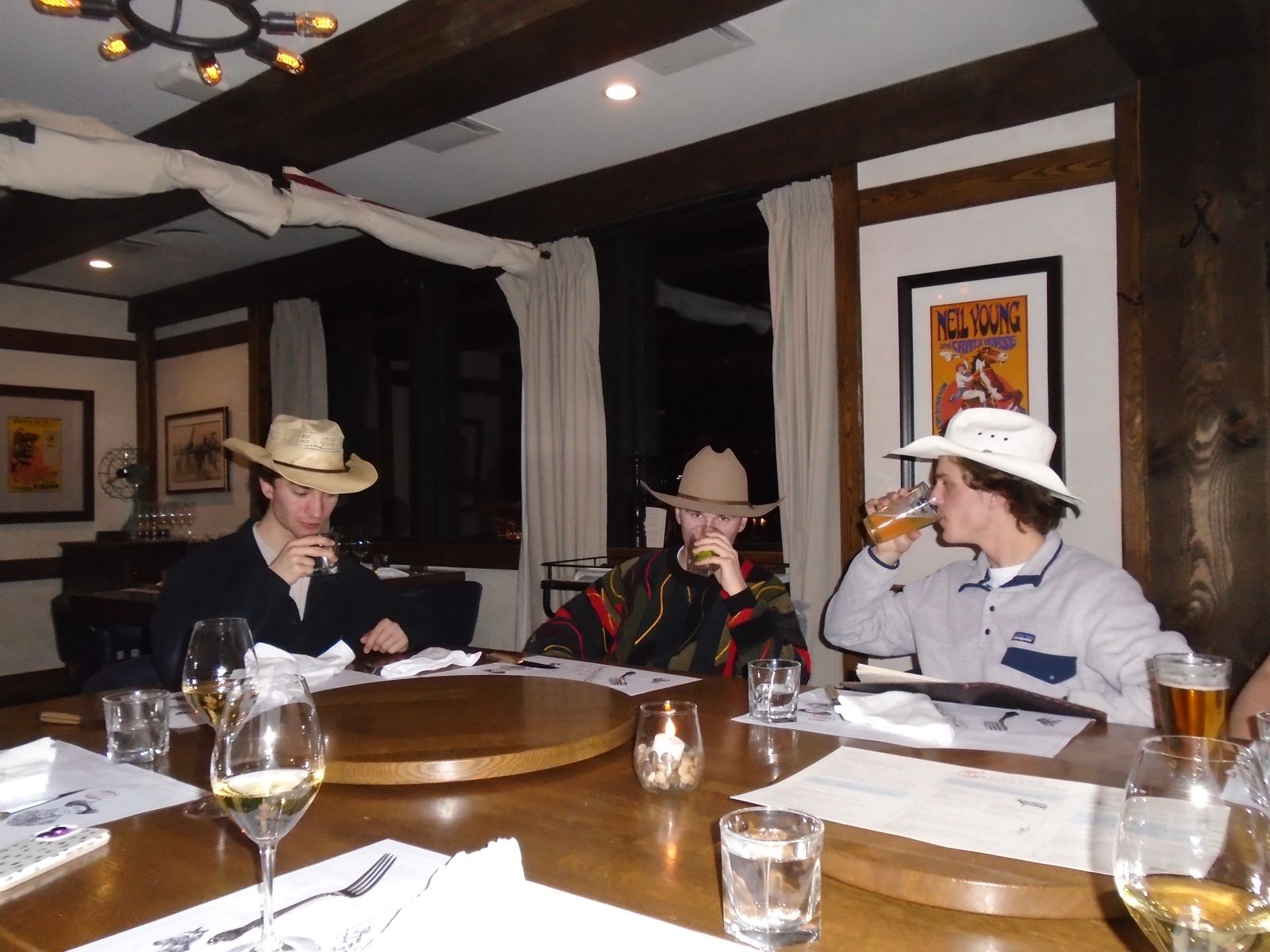 Members in cowboy hats at dinner