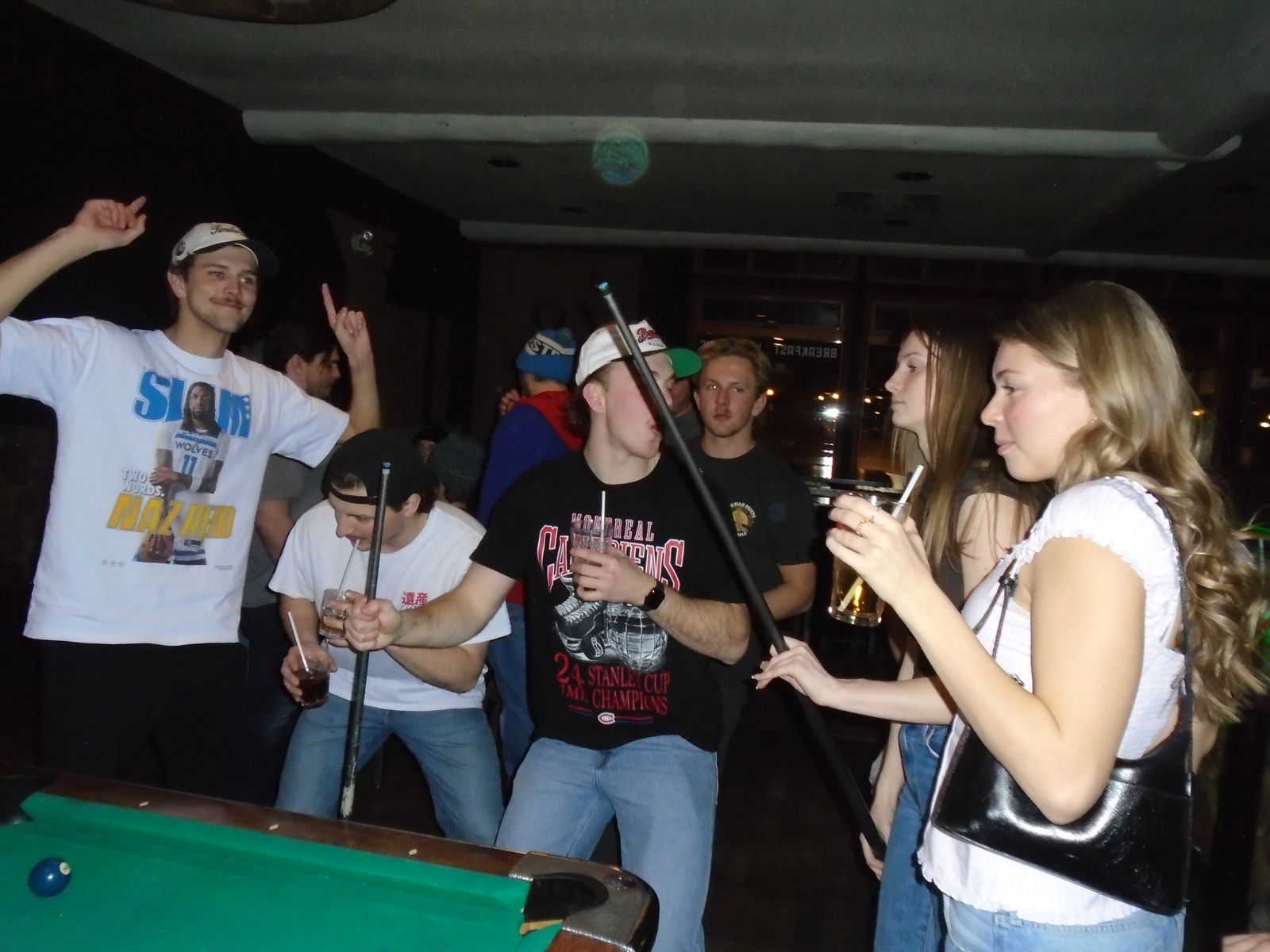 Members celebrating by the pool table
