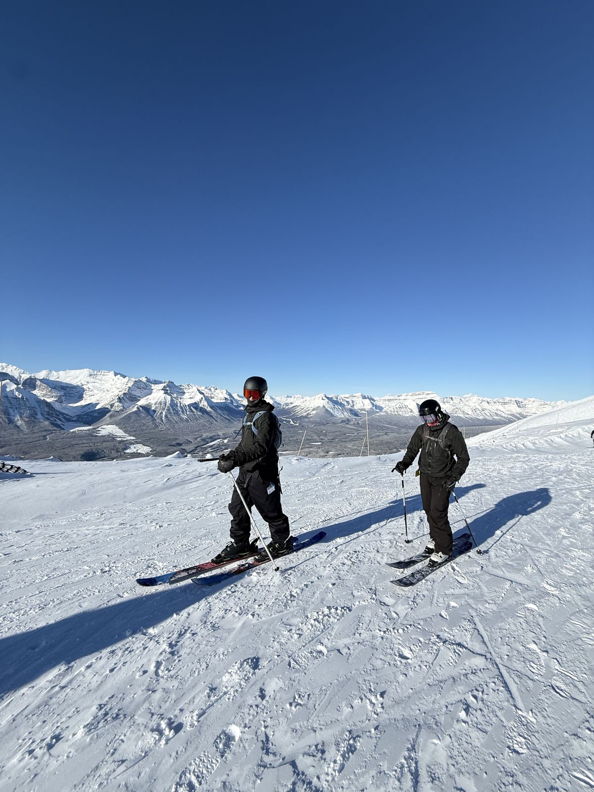 Two skiers at the top of a run