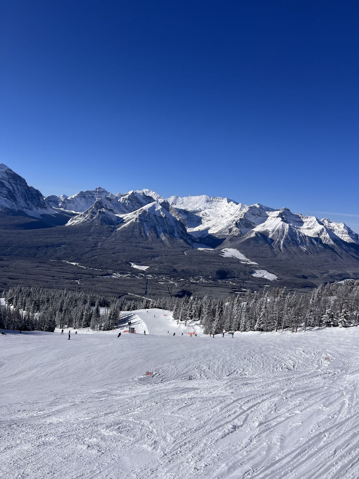 View down a ski run toward the mountains