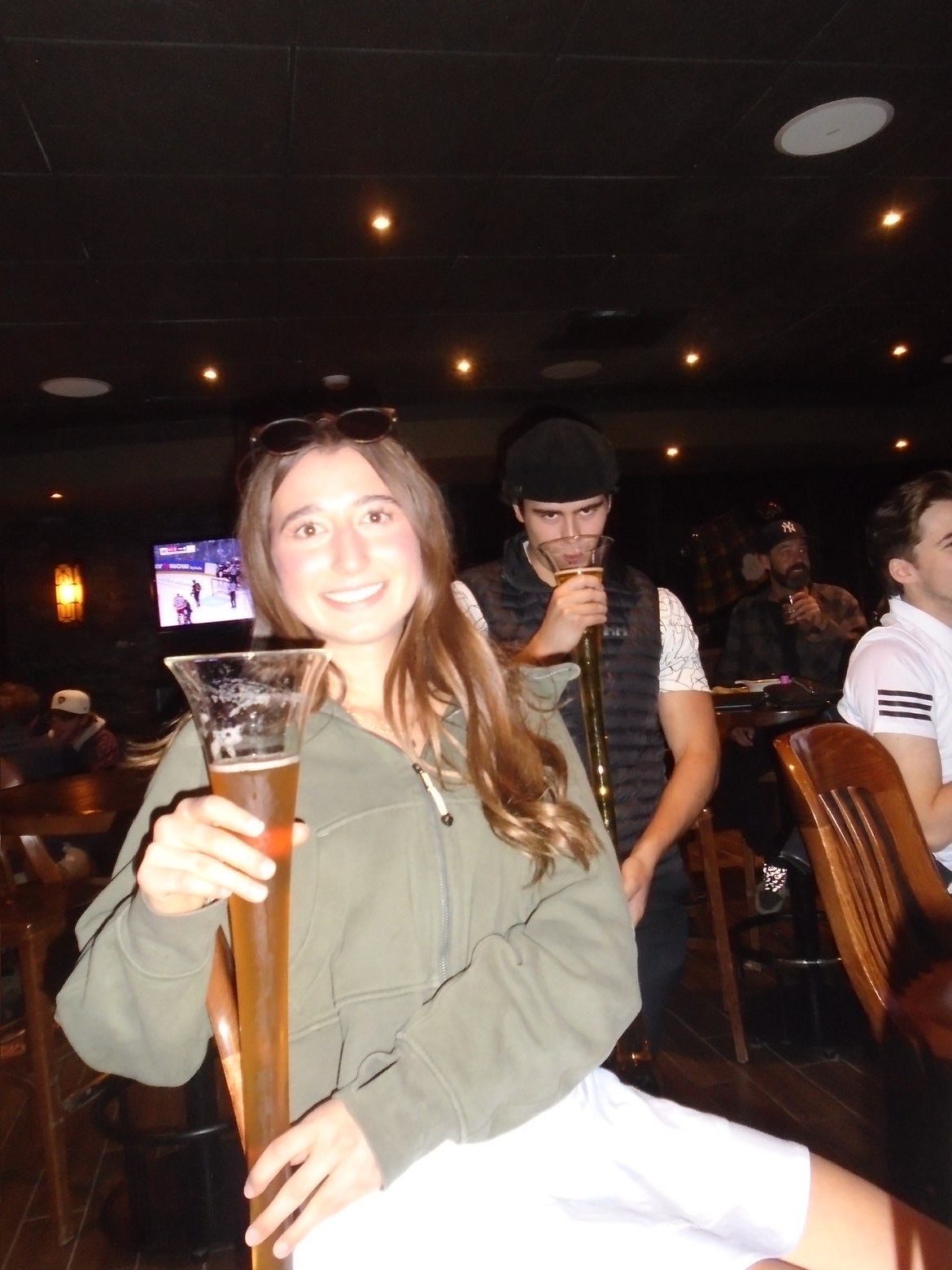 Member smiling with a yard glass