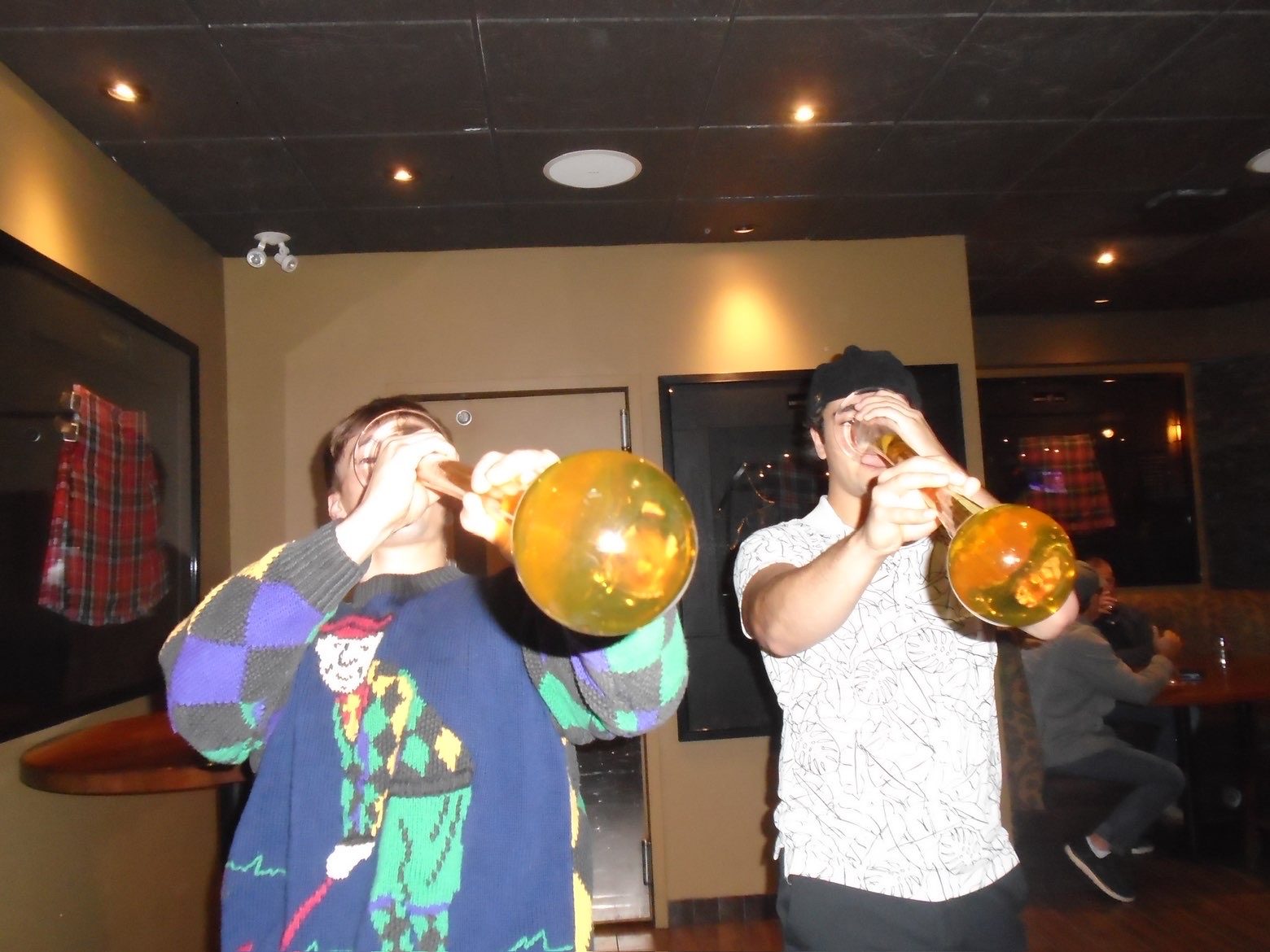 Two members drinking from yard glasses