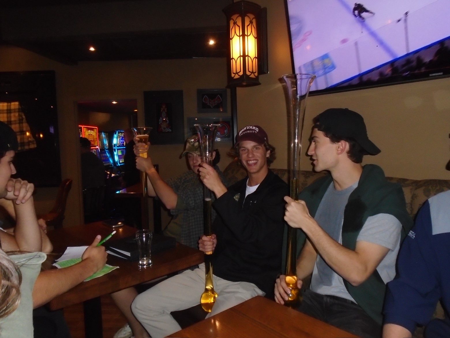 Members with yard glasses around a table