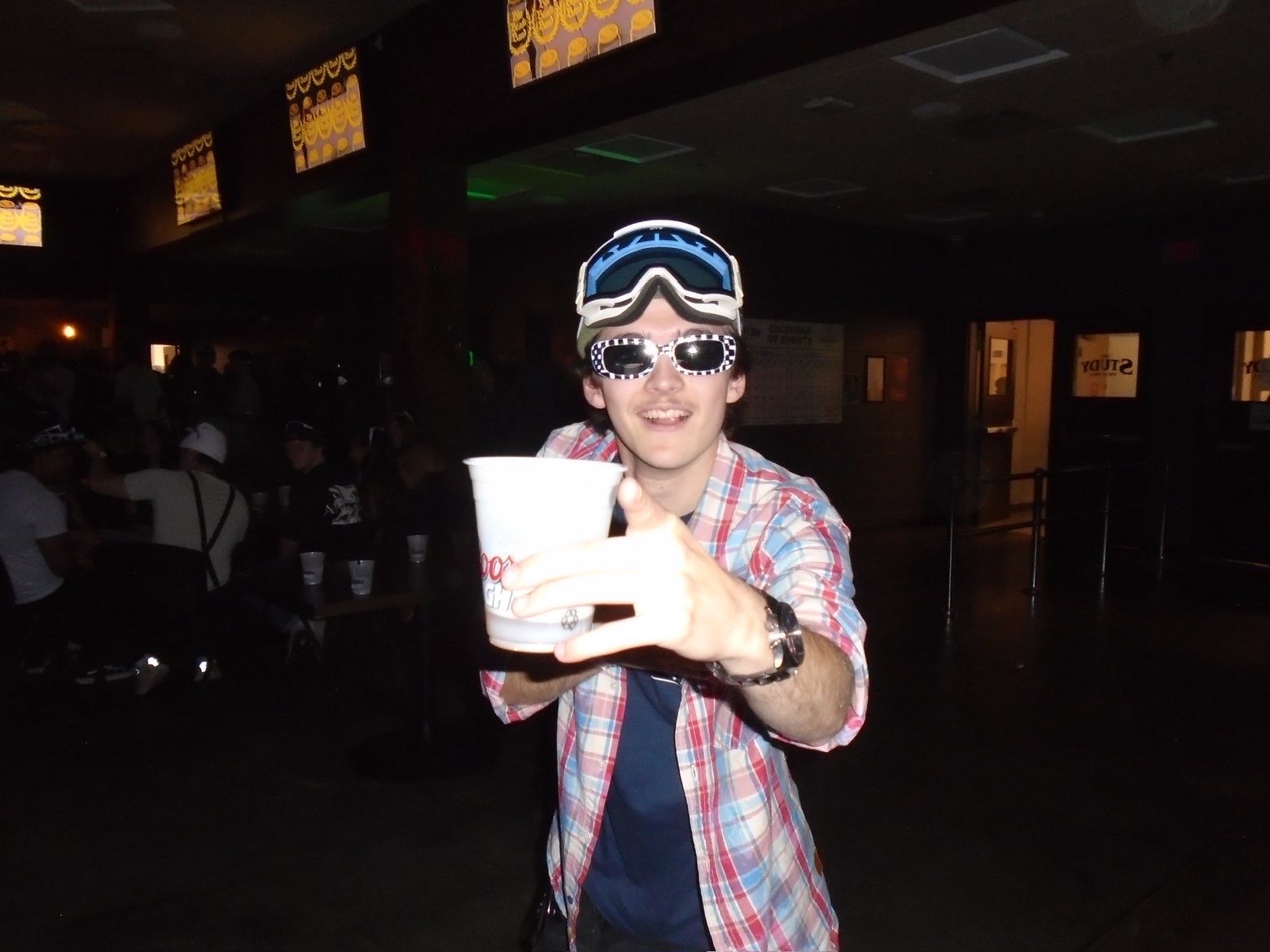 Member in goggles and party glasses raising a cup