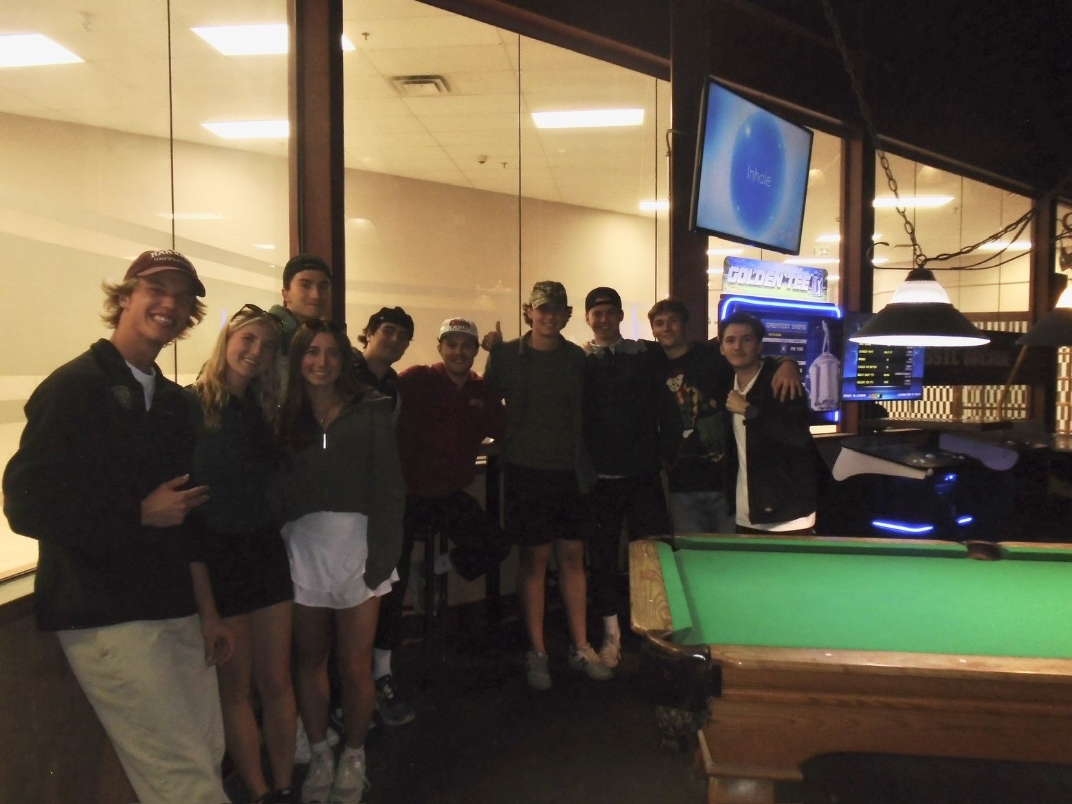 The UofR Ski and Board team together by the pool table